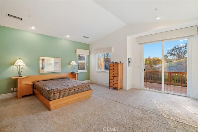 carpeted bedroom featuring lofted ceiling and access to exterior