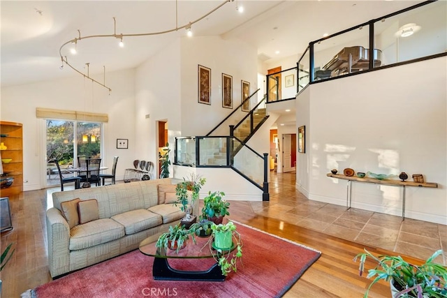 living room featuring wood-type flooring and high vaulted ceiling