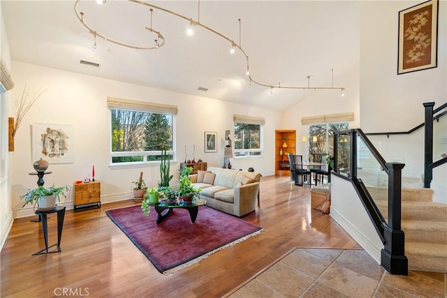 living room featuring wood-type flooring and lofted ceiling