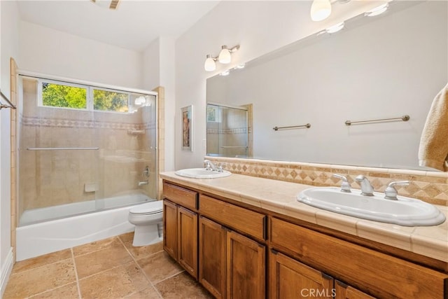 full bathroom with toilet, vanity, shower / bath combination with glass door, and decorative backsplash