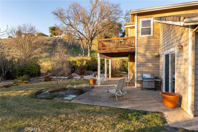 view of yard featuring a wooden deck and a patio