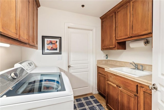 washroom featuring cabinets, separate washer and dryer, and sink