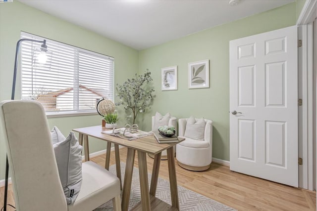 home office with light hardwood / wood-style flooring