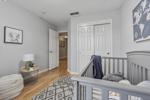 bedroom with hardwood / wood-style floors and a closet