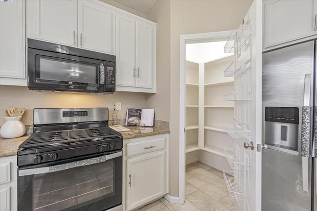 kitchen featuring stone countertops, white cabinets, and appliances with stainless steel finishes