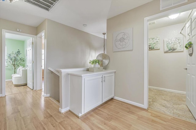 hall with light hardwood / wood-style flooring