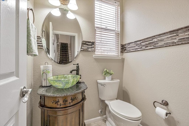 bathroom with vanity, plenty of natural light, and toilet