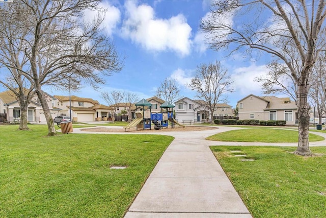 view of community with a lawn and a playground