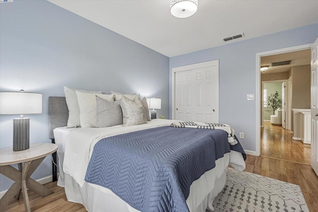 bedroom with light wood-type flooring and a closet