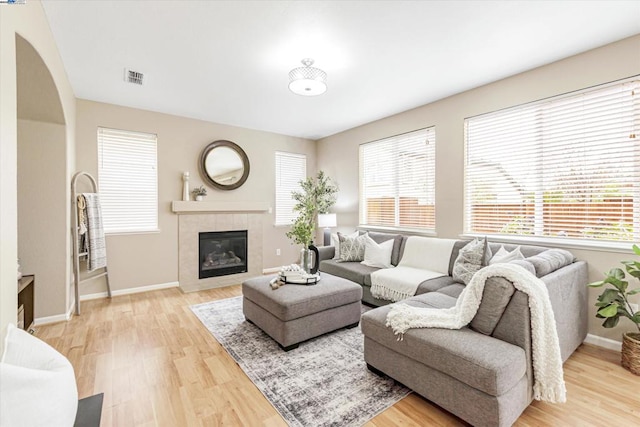 living room with a fireplace and light hardwood / wood-style floors