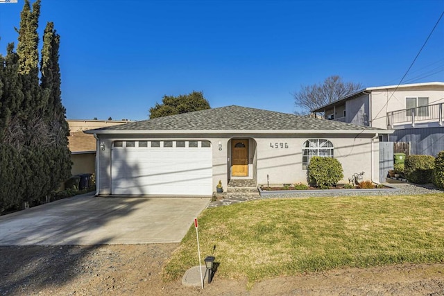 view of front of home with a garage and a front lawn