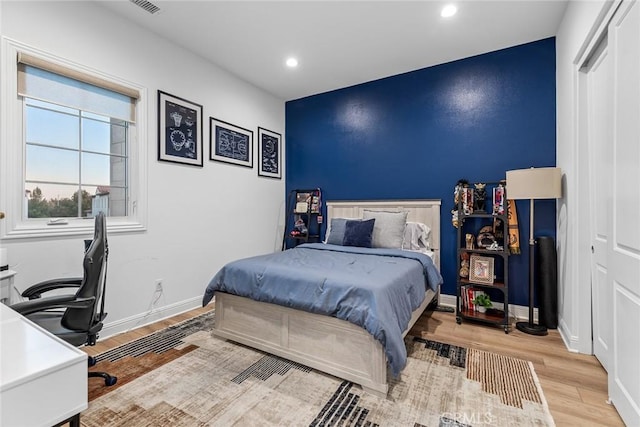 bedroom featuring a closet and light wood-type flooring