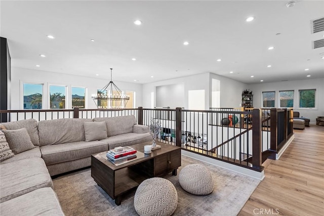 living room featuring an inviting chandelier and light hardwood / wood-style floors