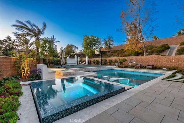 view of swimming pool featuring an in ground hot tub and a patio area