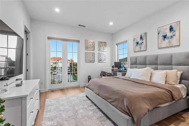 bedroom featuring light hardwood / wood-style flooring and access to outside