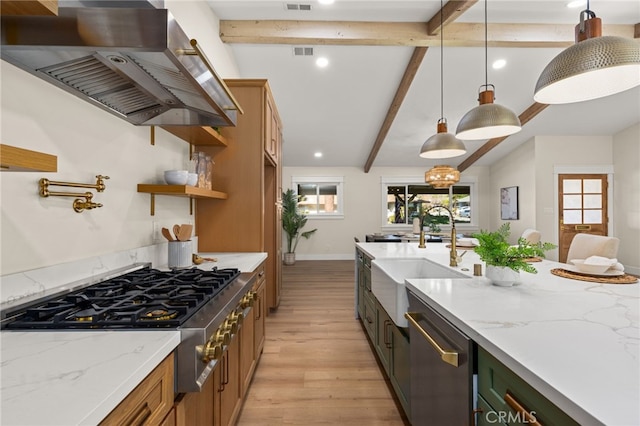 kitchen featuring pendant lighting, ventilation hood, sink, and light stone counters