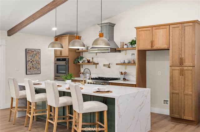 kitchen featuring a kitchen island with sink, stainless steel appliances, island exhaust hood, decorative light fixtures, and light wood-type flooring