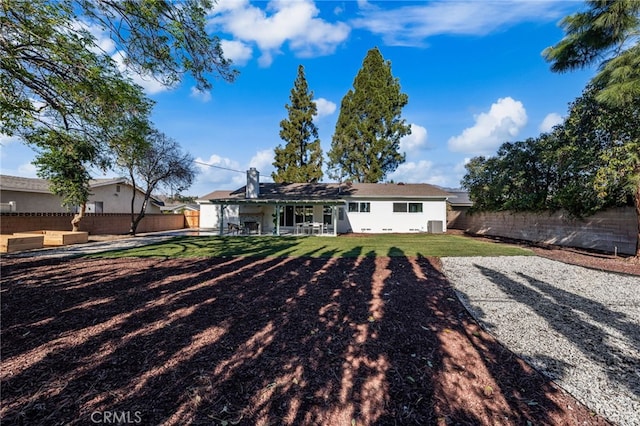 rear view of house with an outdoor hangout area, a patio area, and a lawn