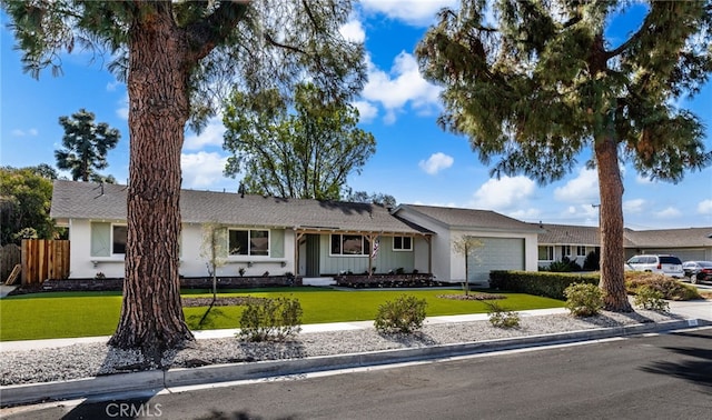 ranch-style home with a garage and a front yard