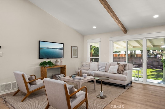 living room with lofted ceiling with beams and light wood-type flooring