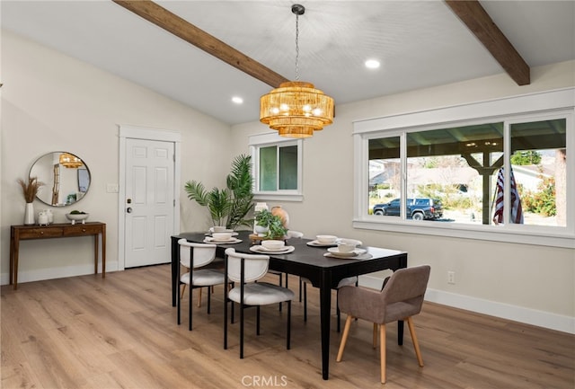 dining room featuring lofted ceiling with beams and light wood-type flooring