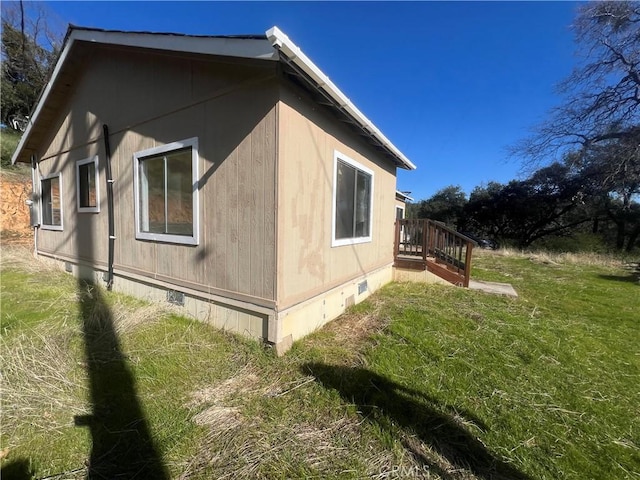 view of home's exterior with a lawn