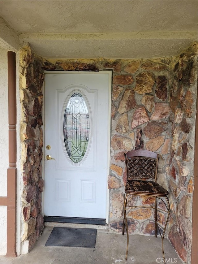 entrance to property with stone siding