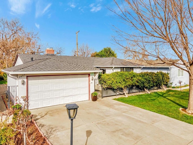 ranch-style home with a garage and a front yard