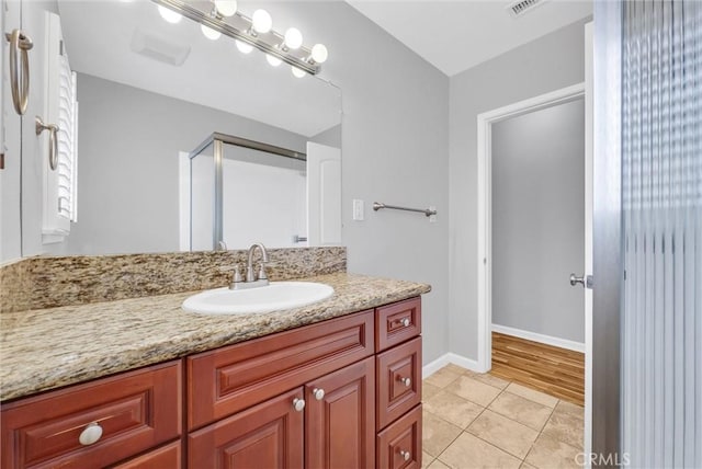 bathroom with tile patterned flooring, visible vents, vanity, and baseboards