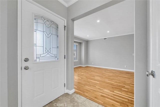 entrance foyer featuring ornamental molding, recessed lighting, light wood-style flooring, and baseboards