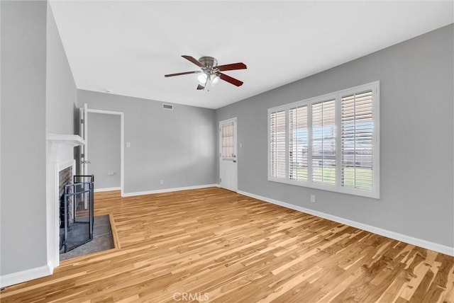 unfurnished living room featuring hardwood / wood-style flooring and ceiling fan