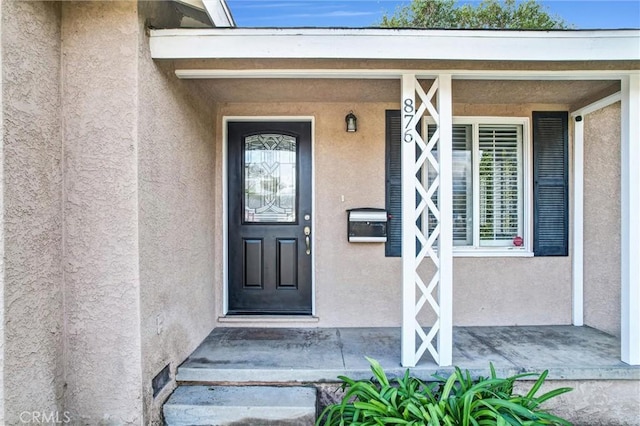 doorway to property with stucco siding