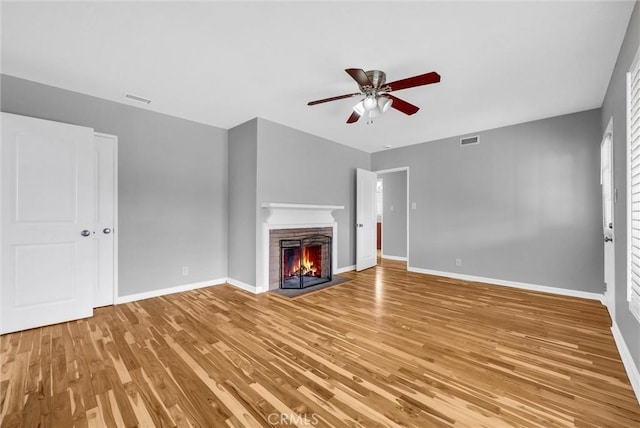 unfurnished living room featuring wood-type flooring and ceiling fan