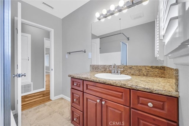 bathroom with baseboards, visible vents, tile patterned flooring, and vanity