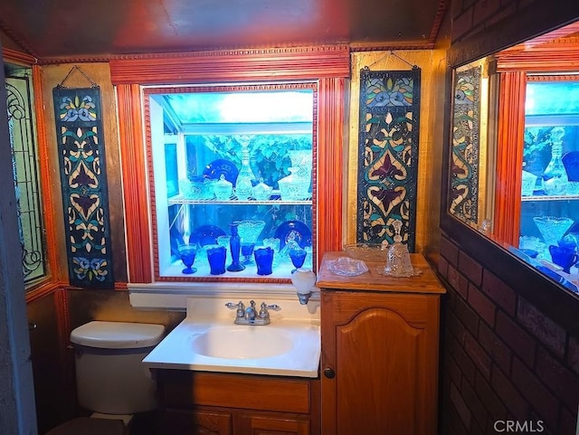 bathroom featuring vanity, plenty of natural light, and toilet