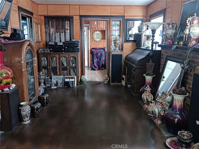 interior space featuring hardwood / wood-style flooring, a fireplace, and wood walls