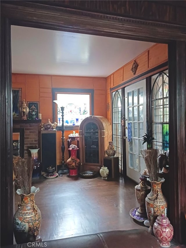 foyer entrance featuring wood walls