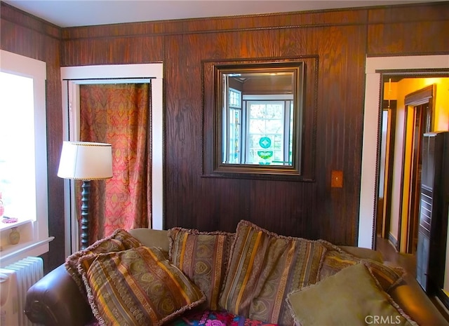 interior space with radiator heating unit and wood walls