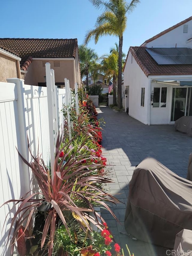 view of property exterior with a patio area