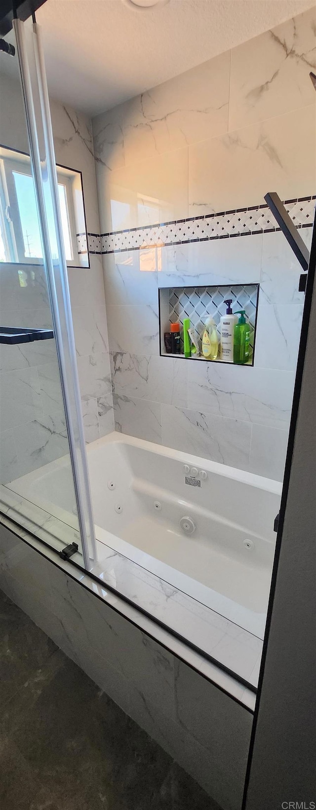 bathroom featuring shower / bath combination with glass door