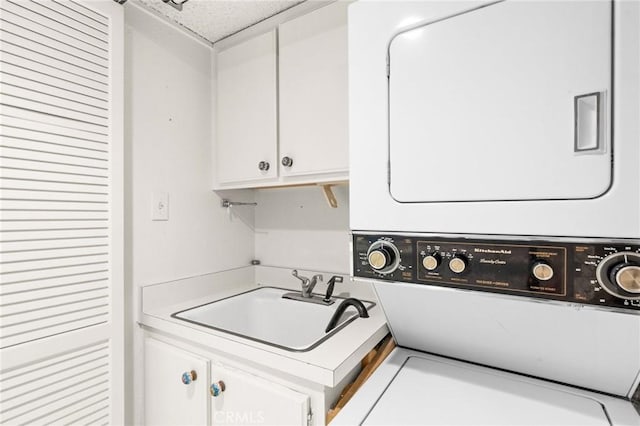 washroom with stacked washer and clothes dryer and a sink