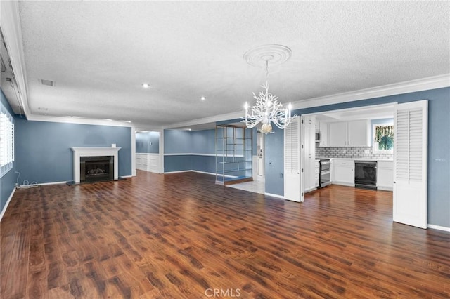 unfurnished living room featuring dark wood-style floors, ornamental molding, a textured ceiling, and a fireplace