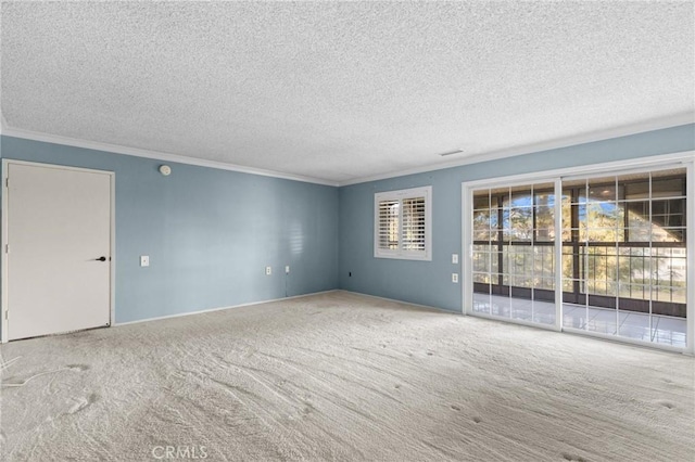 empty room with a textured ceiling, carpet, visible vents, and crown molding