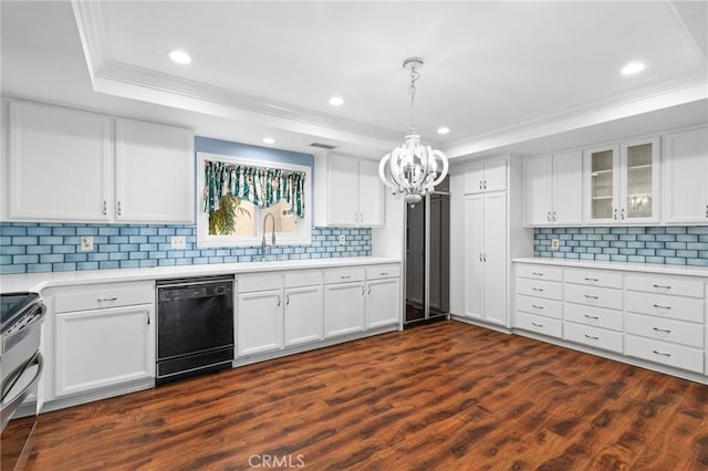 kitchen with dark wood-type flooring, a sink, black dishwasher, double oven range, and a raised ceiling