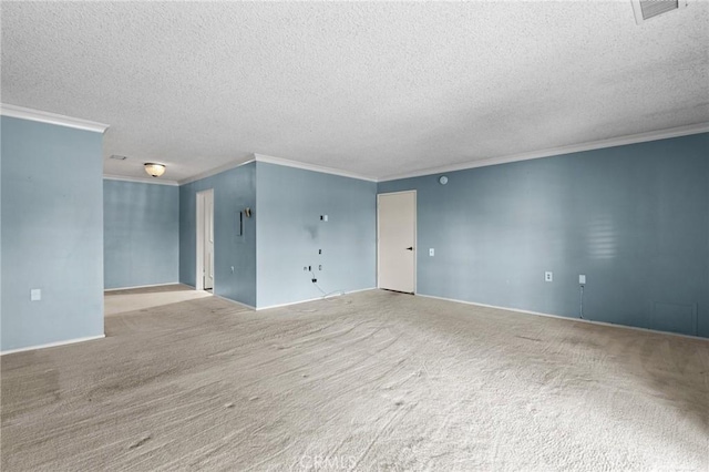 empty room featuring ornamental molding, visible vents, a textured ceiling, and carpet flooring