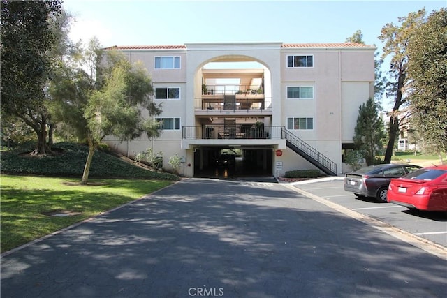 view of building exterior featuring uncovered parking