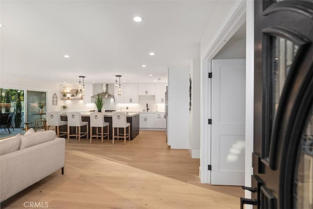 living room with sink and light hardwood / wood-style flooring