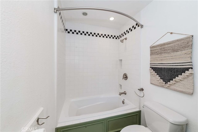 bathroom featuring toilet and tiled shower / bath combo