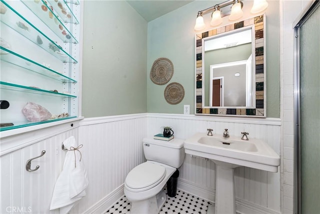 bathroom featuring tile patterned flooring, sink, and toilet