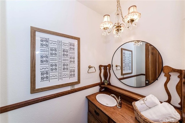 bathroom featuring vanity and a notable chandelier